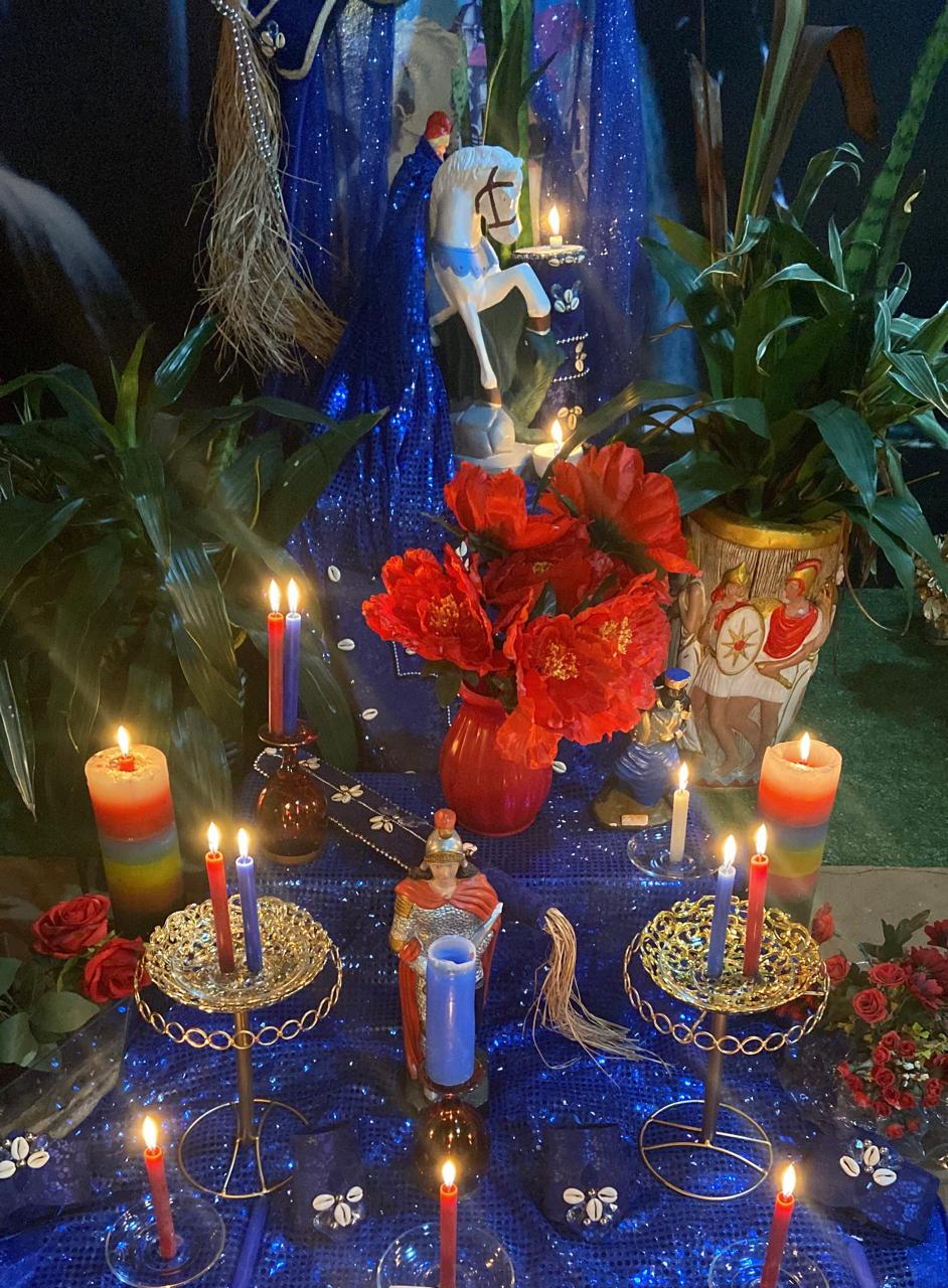 Oferenda à beira-mar com imagem de Iemanjá, velas e adornos